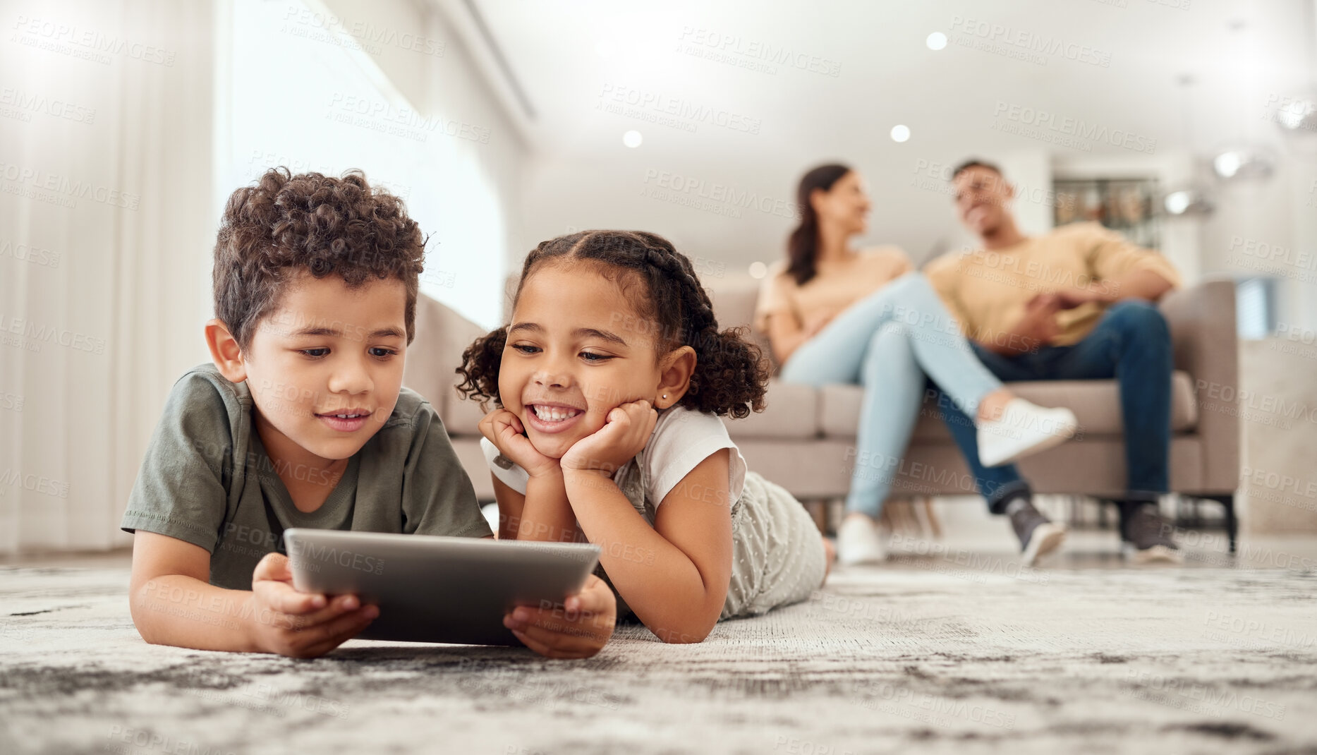 Buy stock photo Learning, tablet and children streaming a video on technology on the living room floor of their house. Education, happiness and movies on technology for kids with parents on the sofa in their home