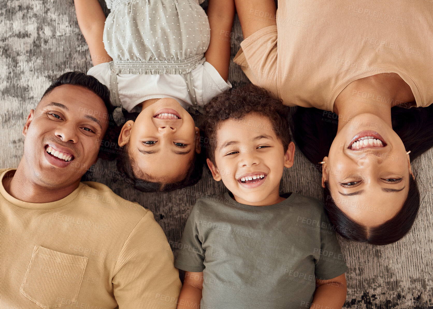 Buy stock photo Children, parents and lying on floor from above, happiness spending time together in family home. Mom, dad and young kids smiling on carpet, happy home Brazil for future fun and laughing on weekend.