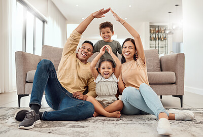 Buy stock photo Roof, portrait and happy family with safety gesture while sitting in the living room of their home. Happiness, protection and children with parents relaxing together with mortgage or house insurance.