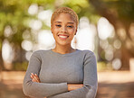 Nature, park and portrait of woman with arms crossed, happy and smile on face. Young black woman enjoying weekend, freedom and holiday, standing in forest for happiness, adventure and relax outdoors
