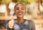 Thumbs up, support and woman with a thank you hand sign in nature. Face portrait of a young, happy and girl with smile for agreement, success and excited about summer in a garden, park or forest