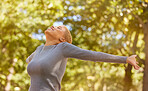 Happy, woman and freedom in nature park, sunlight and natural fresh air. Dance, happiness and calm young latino girl with smile in  outdoor fun on spring holiday in a forest during a walk or hike
