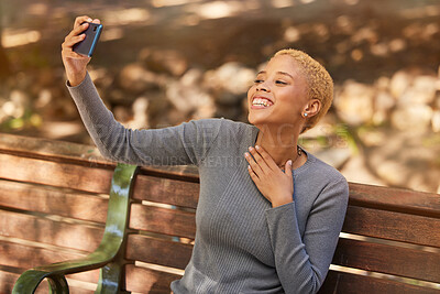 Buy stock photo Park bench, phone selfie and black woman in nature outdoors taking picture. Happy, smile and girl from South Africa with 5g mobile for photo, social media post or comic memory alone at park outside.
