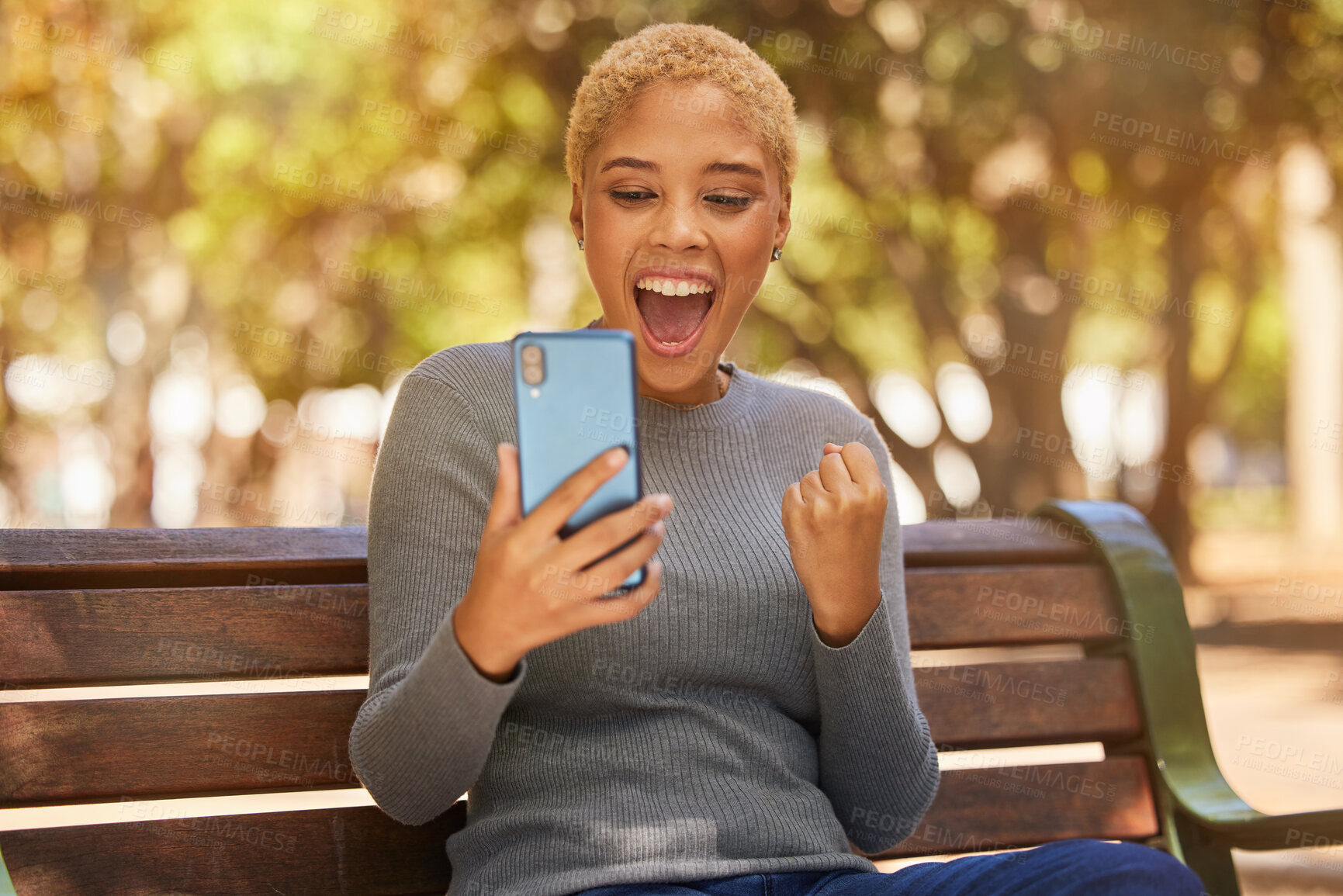 Buy stock photo Phone, success and woman excited about trading on the internet while on a bench in the park. Young, happy and girl with wow face for communication on a mobile app, celebration and winning in nature