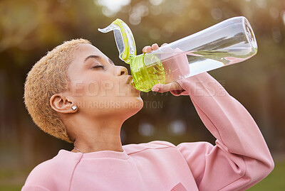 Buy stock photo Fitness, water bottle and woman outdoor in nature park for exercise, training and run for health, wellness and hydration during workout. Fit athlete female feeling thirsty and drinking healthy drink
