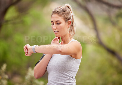 Buy stock photo Fitness, woman and watch checking time in nature for exercise, workout or training in the outdoors. Active female runner looking at wrist monitoring heart rate, pulse or activity for healthy cardio