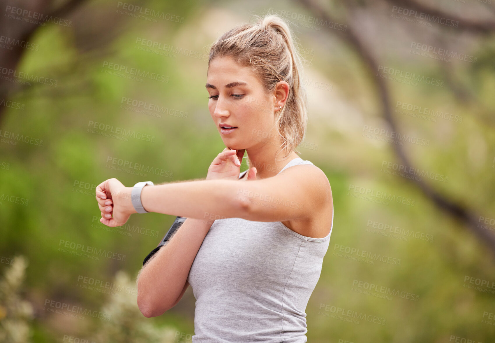 Buy stock photo Fitness, woman and watch checking time in nature for exercise, workout or training in the outdoors. Active female runner looking at wrist monitoring heart rate, pulse or activity for healthy cardio