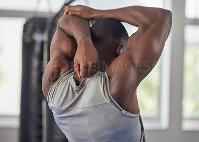 Buy stock photo Fitness, bodybuilder and black man stretching at gym for training, exercise and workout for strong powerful muscles. Back view, sports and healthy athlete starting biceps, triceps and elbow warm up