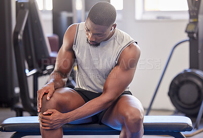 Buy stock photo Black man, fitness and knee injury in gym after workout, training or intense exercise. Earphones, health and bodybuilder male from Nigeria suffering from sore leg, muscle pain or joint inflammation.