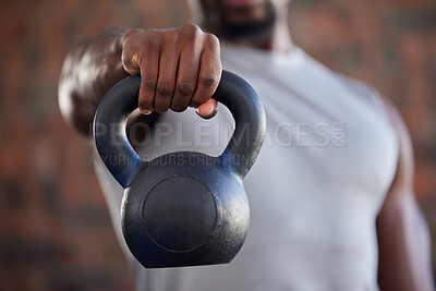 Fitness, bodybuilder and black man kettlebell training, exercise or workout for powerful arm strength at gym. African, hand and strong sports athlete bodybuilding or weightlifting in a health club