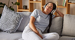 Relax, music and peace with woman on sofa with headphones for sleeping, podcast or wellness. Technology, streaming and service with girl in living room listening for calm, spiritual and lifestyle