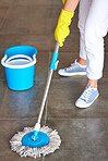 Woman, mop or bucket in floor cleaning at home or office building by cleaner service, maid or housekeeping worker. Person mopping, healthcare maintenance or water container in bacteria safety control