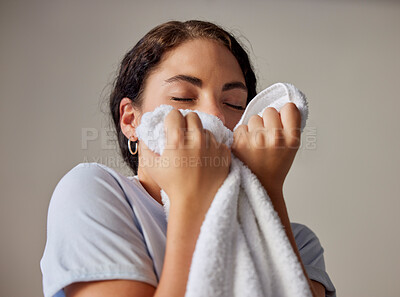 Buy stock photo Woman smelling a clean towel after doing laundry at her home, hotel or resort while spring cleaning. Housekeeping, maid or housewife doing washing for maintenance, hygiene and fresh fabrics or cloth.