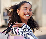 Shopping, rich and woman in urban city for fashion, clothes or retail sale discount and promotion. Store, boutique or mall girl customer portrait and shopping bag for wealth, choice in outdoor street