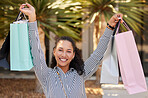 Retail, portrait and happy woman shopping for fashion sales deals, clothes promotion and clothing deals outdoors. Smile, happiness and excited young customer with bags from a fancy boutique store 