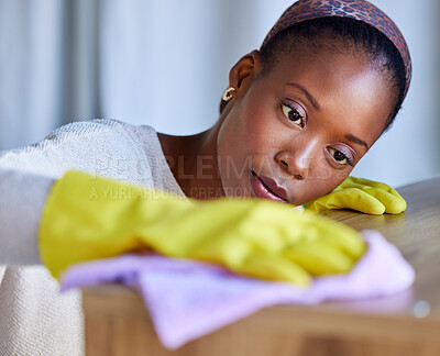 Buy stock photo Cleaning, hygiene and wipe with a black woman cleaner using a cloth to wipe a wooden surface in her home. Dust, service and housekeeper with a female washing furniture in her house for cleanliness