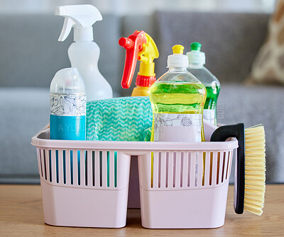 Buy stock photo Cleaning supplies, brush and basket tools on table in home living room for hygiene. Cleaning products, spring cleaning and equipment for creating germ free living space, sanitizing or washing.


