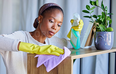 Buy stock photo Cleaner, house and black woman cleaning dust on furniture, tables and wood with liquid soap in spray bottle and cloth. Services, maid and worker with gloves working to wash dirty or messy shelves