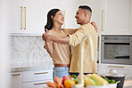 Couple, love and dancing together in kitchen happy at home bonding, spend time and relax. Young married latin man and woman, romance bonding and having fun laughing or celebrate healthy relationship