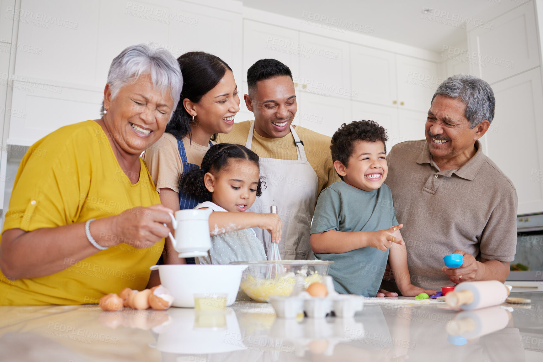 Buy stock photo Baking, comic and big family in the kitchen for food, cooking and happy together in their house. Funny children with parents and grandparents learning to make cookies, cake or lunch with smile