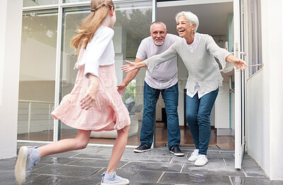 Buy stock photo Grandparents, child and welcome for girl running to hug her grandma and grandpa at front door of home. Excited kid bonding, love and hugging senior man and woman for a family visit in Germany