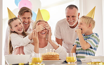 Buy stock photo Surprise, mother birthday and family celebrate at a party at home with a happy smile. Mama, father and children with happiness and excited joy in a house with event food, cake and candles for mom