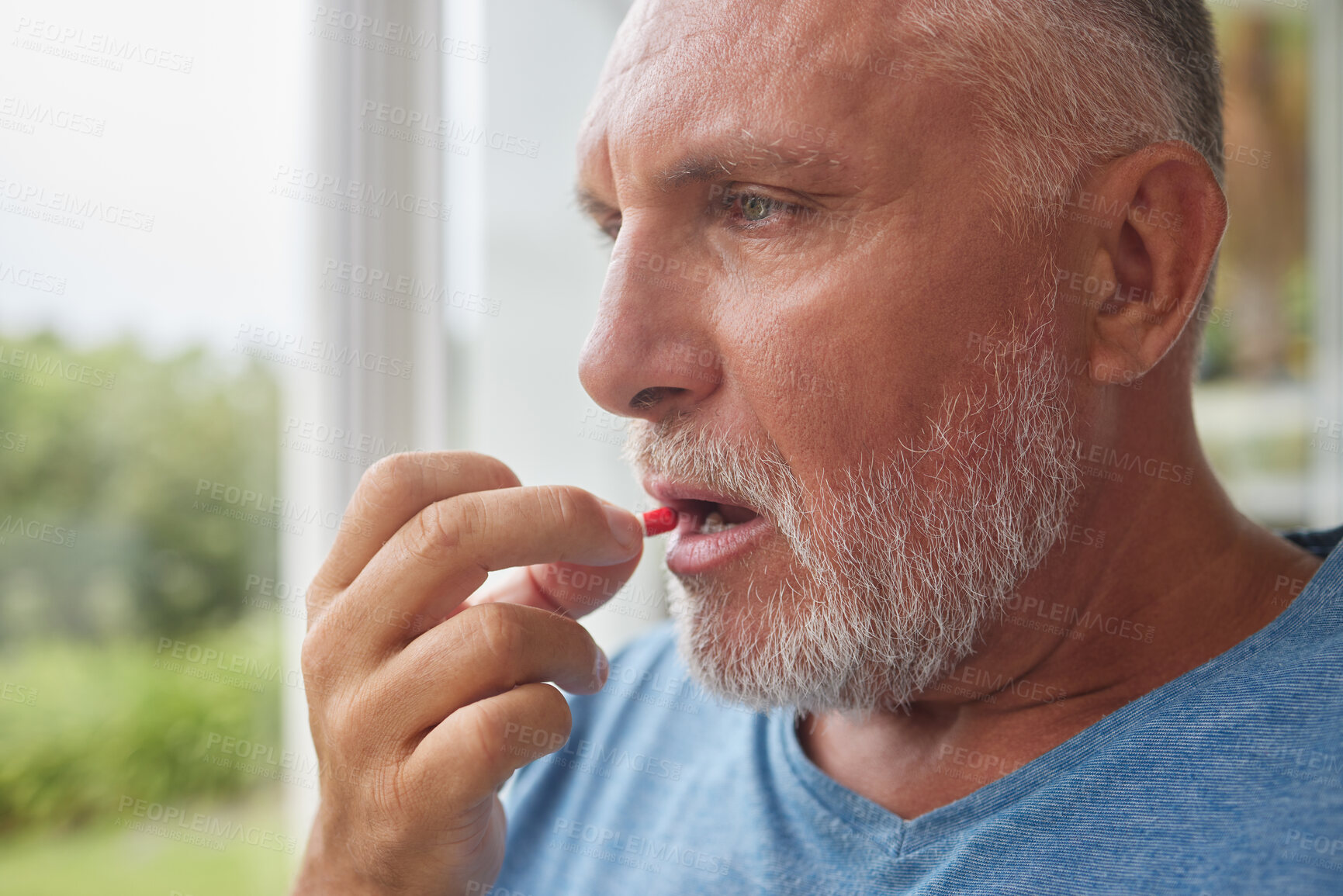 Buy stock photo Retirement man and depression pills in hand for mental health with pensive stare at window. Thinking face of senior male with medicine for self care and wellbeing in Canada nursing home.

