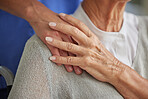 Closeup, hand and nurse with senior for care in wheelchair at house, nursing home or retirement. Zoom, hands and touch on shoulder for compassion, elderly and support for healthcare in disability