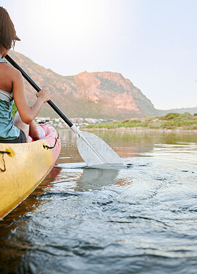 Buy stock photo Woman rowing a kayak or boat on a river or lake while on summer vacation or travel. Tourist explore nature on water during a tropical adventure kayaking in the wildlife on summer holiday or vacation
