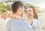 Travel, love and couple embrace at a beach, smile, relax and bonding outdoors together at sunset. Happy, smile and woman hug man, enjoying conversation and relationship by the sea in South africa