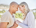 Beach, happy and interracial couple holding hands on holiday after marriage in Brazil together. Young, smile and man and woman with love on travel vacation by the ocean for vacation during summer