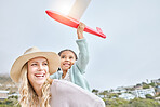 Happy, mother and Girl with airplane toy on travel vacation  by seaside for fun activity with energy. Smile, woman and kid on tropical family holiday in costa rica with daughter and mom enjoy playing