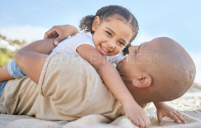 Buy stock photo Girl, dad and lying on blanket, beach and smile on travel, holiday or summer for family, happiness and sand. Happy, child and father together with sunshine, relax or hug at ocean, bonding or vacation