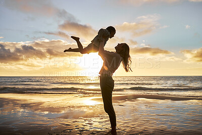 Buy stock photo Mother, girl and sunset silhouette at beach while play, lift and love during summer vacation in Hawaii. Woman, child and energy with fun, carry and care during family travel holiday at Hawaii sea
