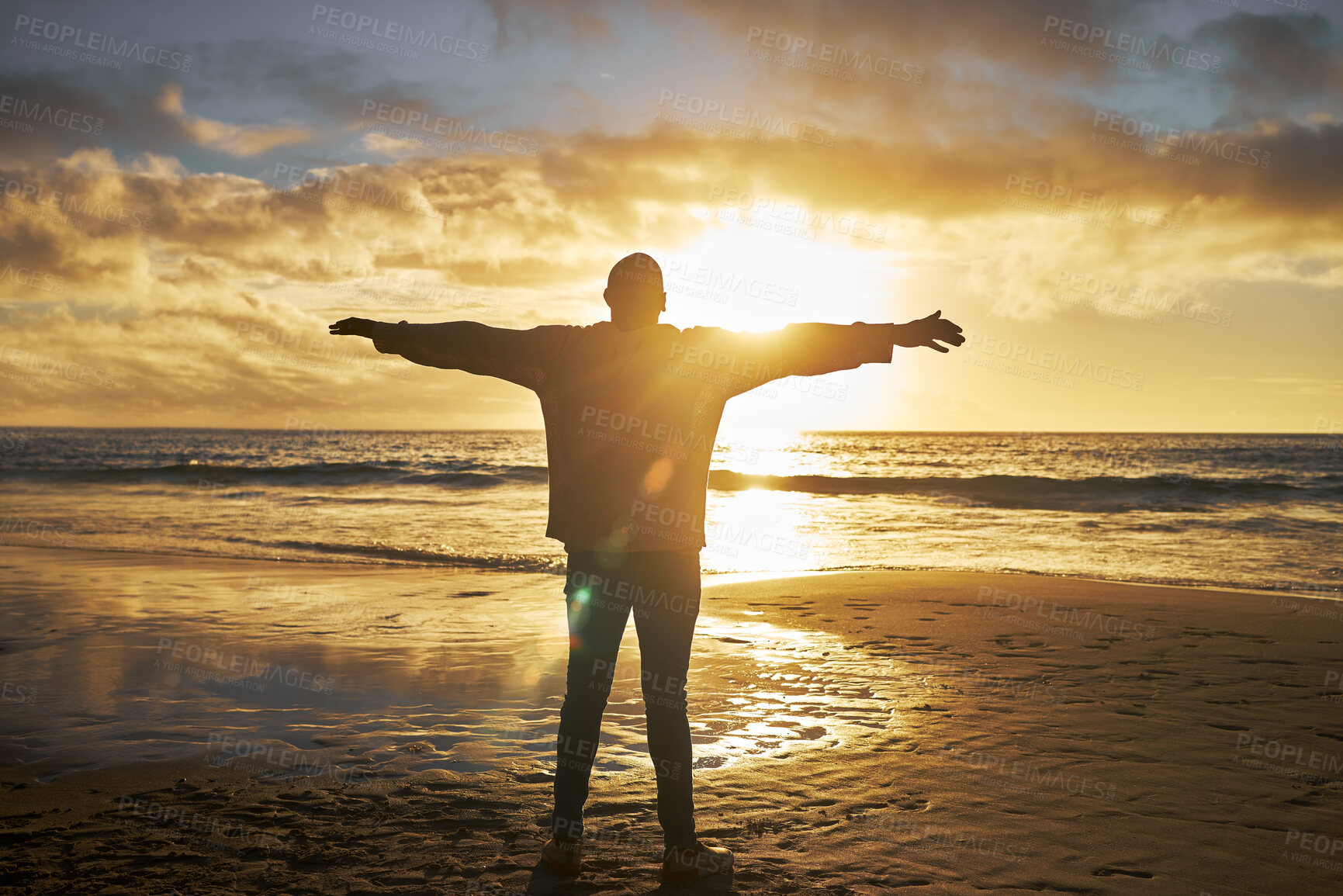 Buy stock photo Worship, sunrise and silhouette of man at the beach standing with arms raised. Faith, religious and spiritual person looking at sun, ocean and sky in morning feeling calm, peace and hope in nature