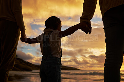 Buy stock photo Parents, child and silhouette of holding hands on the beach during sunset for family bonding in the outdoors. Kid hand, mother and father enjoying the scenic view, care and freedom on the ocean coast