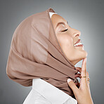 Face, beauty or skincare with a woman muslim wearing a hijab in studio on a gray background for natural wellness. Cosmetics, happy and skin with an Islam female in a headscarf to promote health