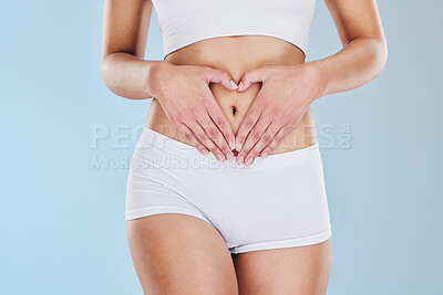 Buy stock photo Wellness, gut health and heart hand sign over a skinny stomach feeling healthy and fit. Body health, happy and wellbeing of a model posing to show love for health care, skincare and skin beauty