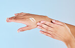 Woman manicure hands, cream and skincare, aesthetic beauty and luxury wellness, cosmetics and dermatology on studio blue background. Closeup moisturizer lotion, fingers and healthy clean body care 