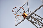 Basketball court, fabric or goals net for match, competition game or fitness in low angle on blue sky in New York. Basketball hoop, texture or sports exercise for training, wellness or winner workout