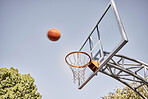 Basketball net, ball and outdoor sports goals, competition game and action on sky background. Background basketball court, shooting hoops and winning target, training skill and fun performance in air