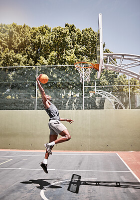 Buy stock photo Basketball, sports and jump with man on court playing games for fitness, training and health. Energy, exercise and workout with basketball player in outdoor for wellness, summer and athlete lifestyle