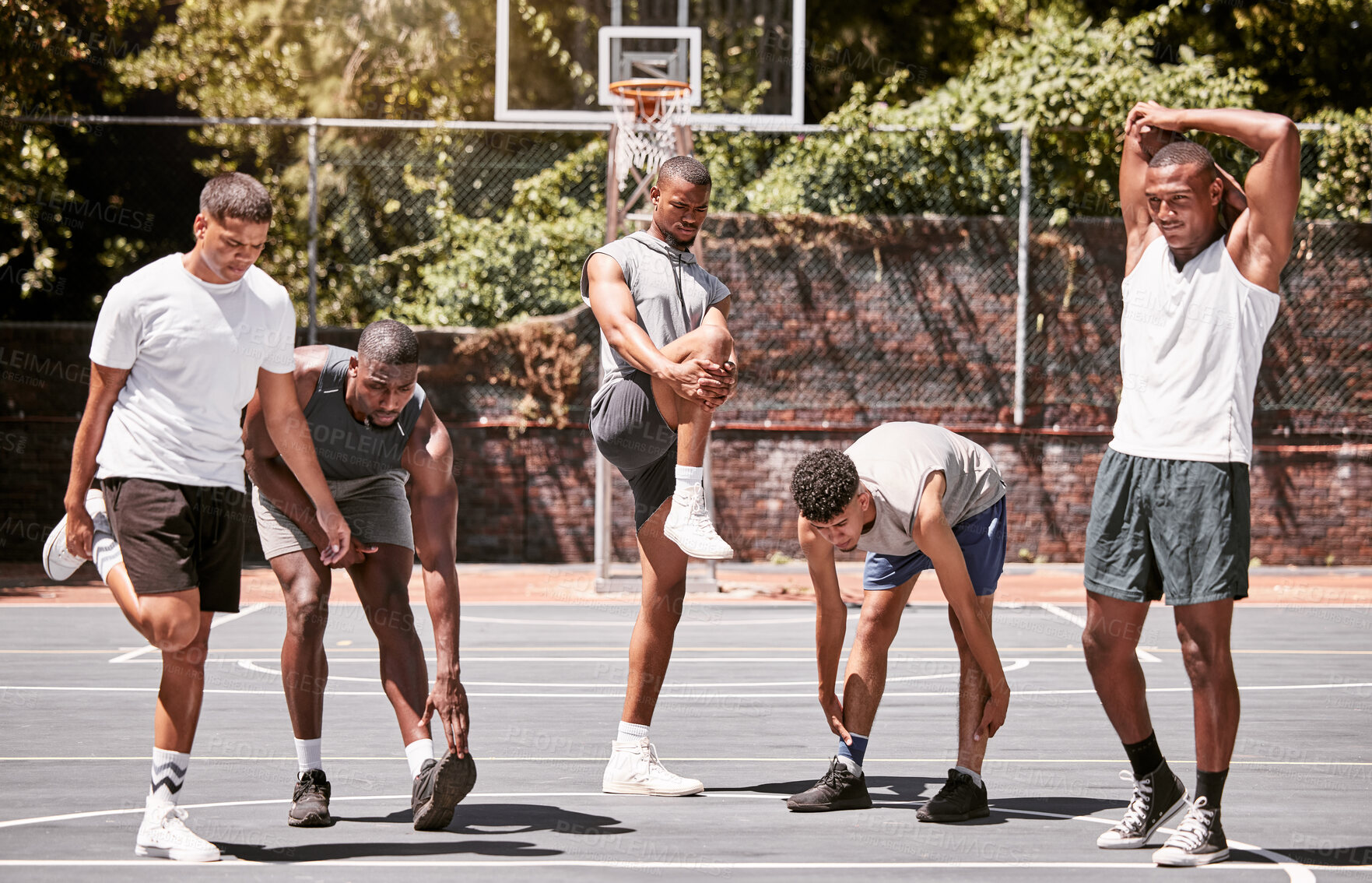 Buy stock photo Fitness, exercise and basketball men stretching or workout their body on a sport court. Training male athletes prepare muscle warm up before practice or game at a sports venue or club for health