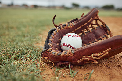 Buy stock photo Baseball, ball and glove on an outdoor pitch for sport training, fitness or a tournament game. Exercise, sports equipment and softball match on a professional field or stadium with grass and sand.