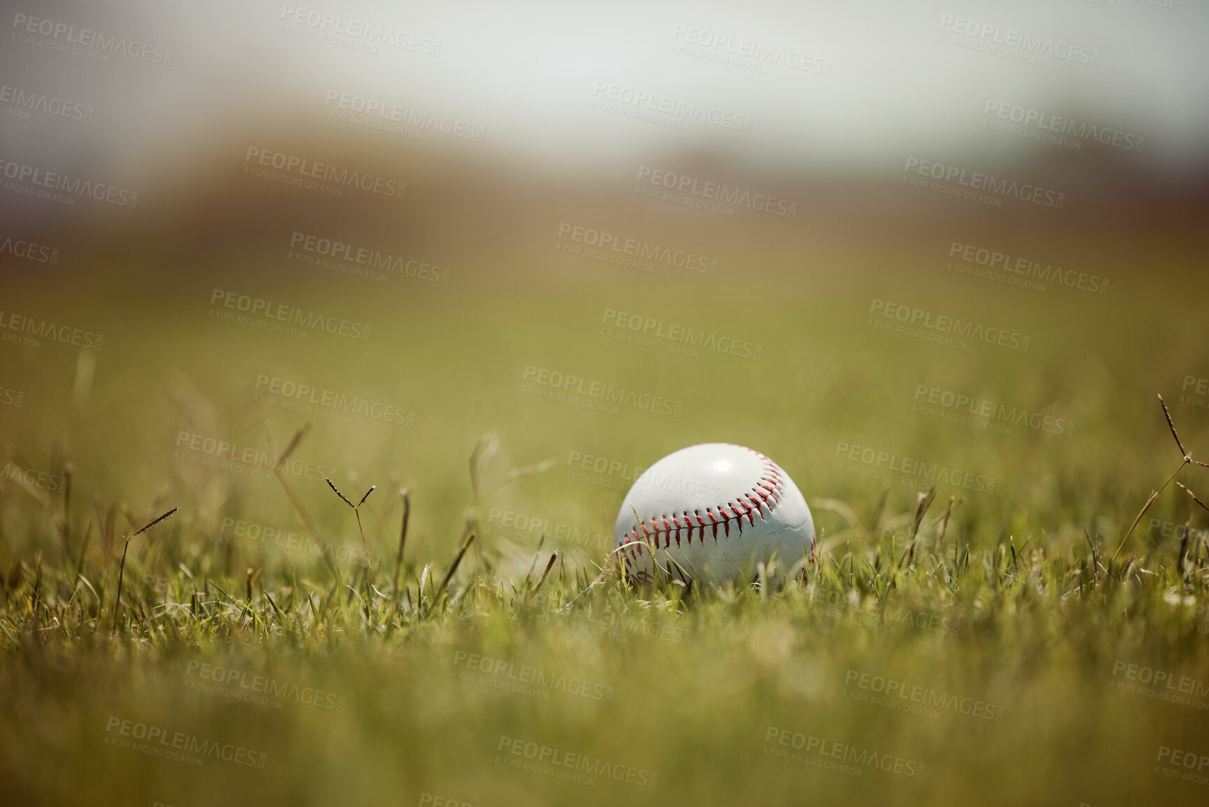 Buy stock photo Baseball, pitch and sports ball on grass on an outdoor field for a game, training or practice. Softball, sport and closeup of equipment for match, practicing or exercise in nature at outside stadium.