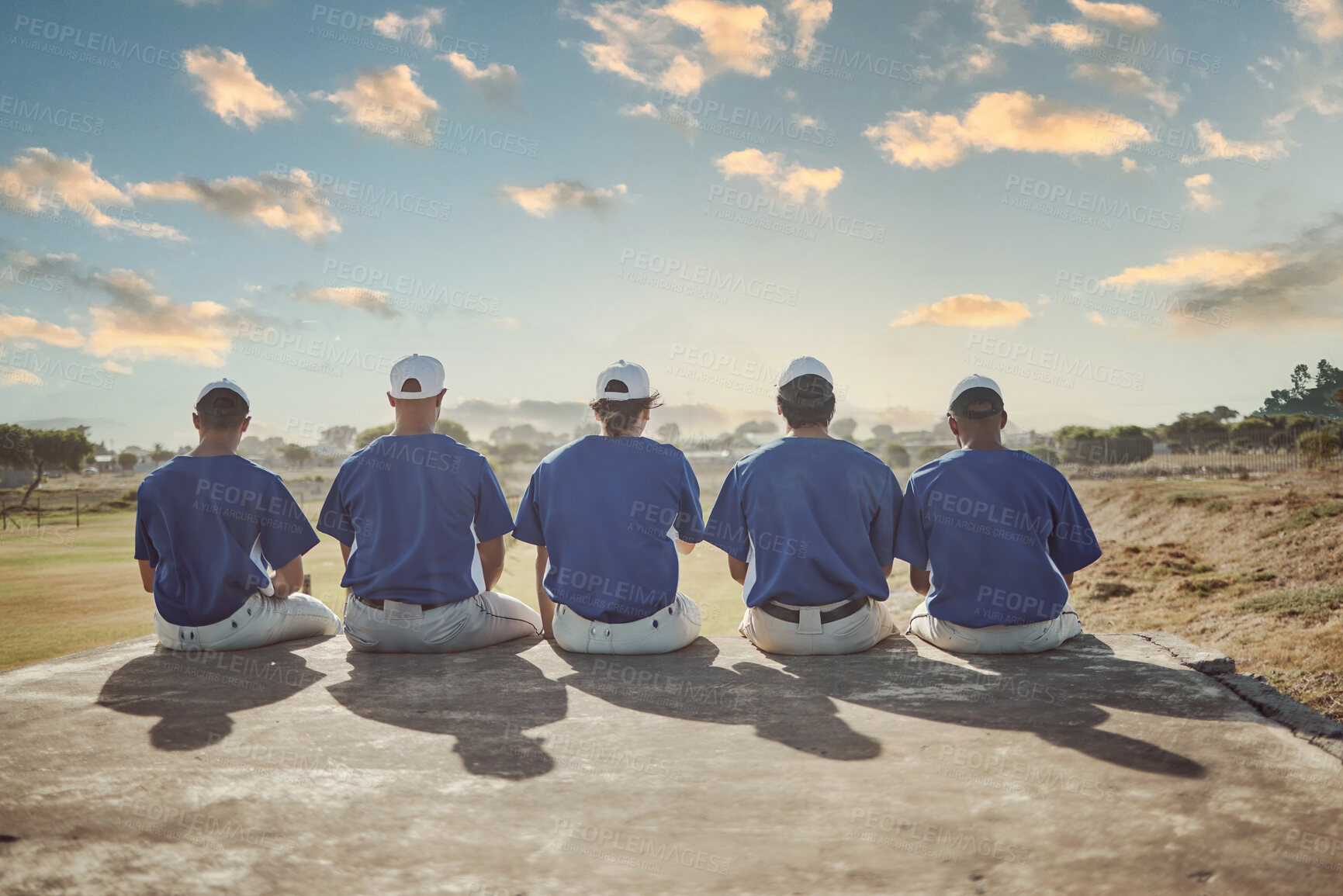 Buy stock photo Baseball, sports and sky with a man team sitting outdoor in a grass pitch or field before a game or match. Fitness, teamwork and view with a male sport group outside together for training or practice