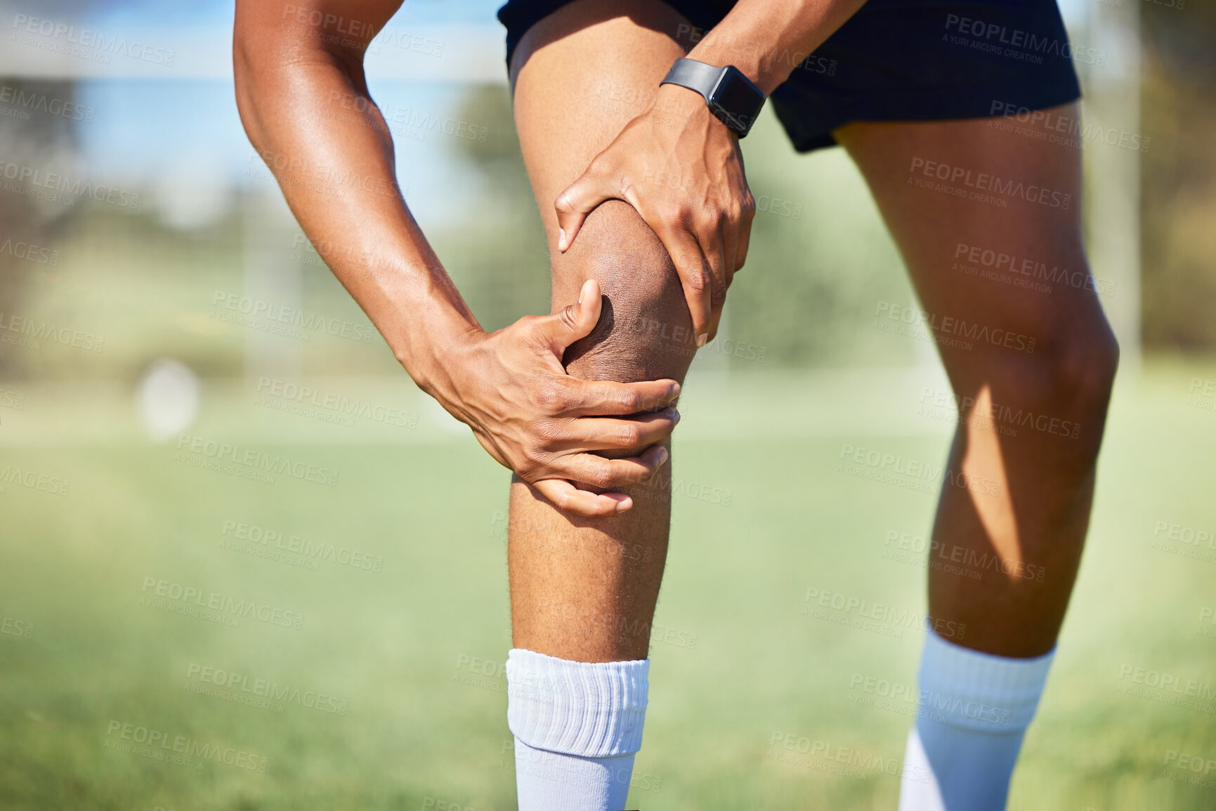 Buy stock photo Sport injury, knee and fitness, soccer field and muscle with pain, soccer player hurt and exercise training. Athlete, hands on injured leg, physical activity and sports, healthy and active lifestyle