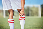 Sports, soccer player and man with knee injury, torn muscle or strain after game, competition or fitness practice. Exercise, grass pitch workout or football training accident for athlete legs in pain