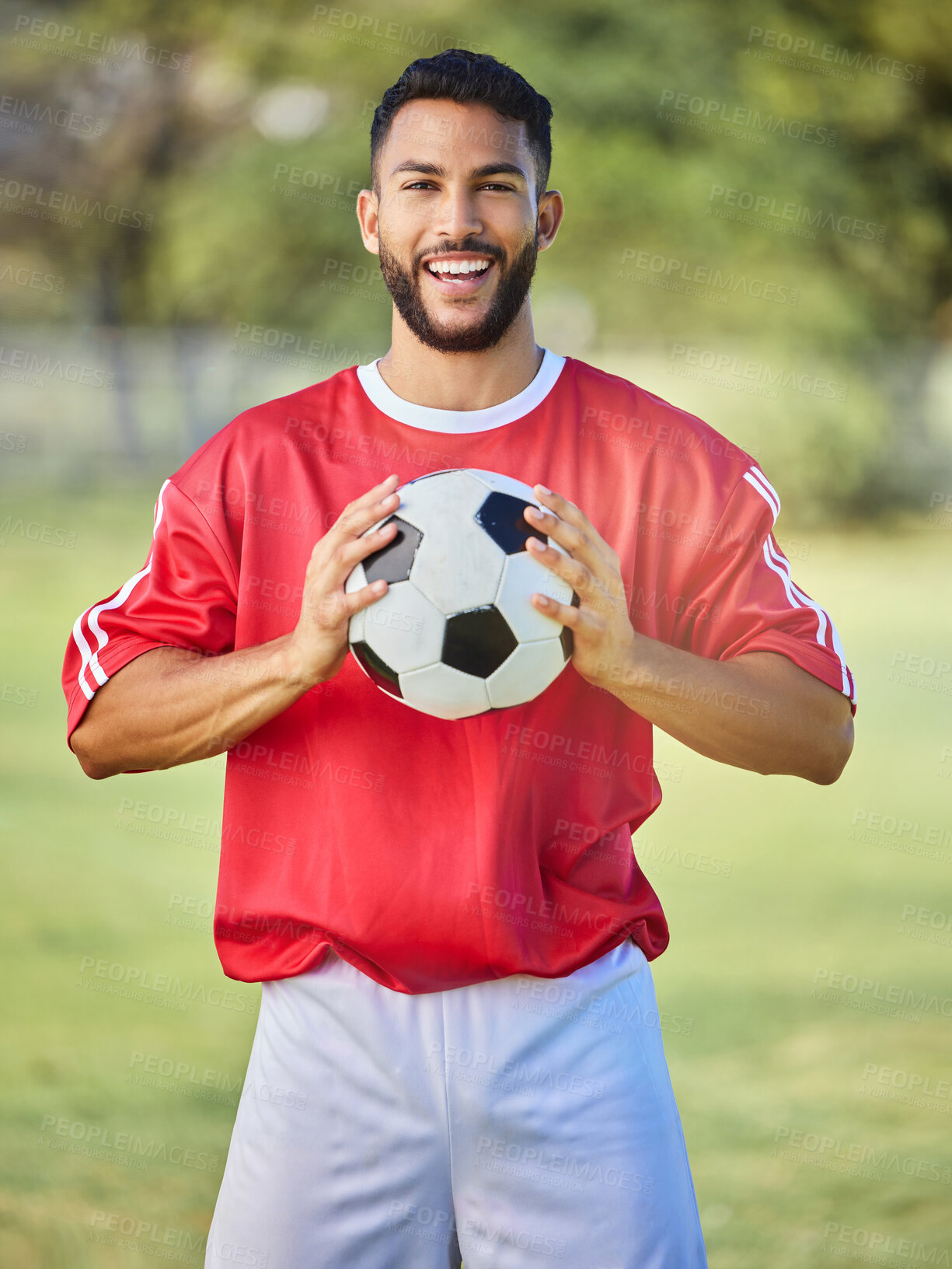 Buy stock photo Soccer, sports and man on a field for a game, training or competition. Portrait of a young, happy and excited athlete with a football during a professional event for sport, fitness and a match