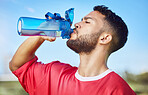 Man, soccer and hydration drinking water for sports motivation, fitness and exercise in the outdoors. Athletic football player with drink for refreshing, thirsty and sustainability for sport workout